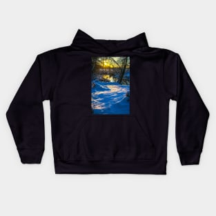 Snow falling on a river with snowy banks Kids Hoodie